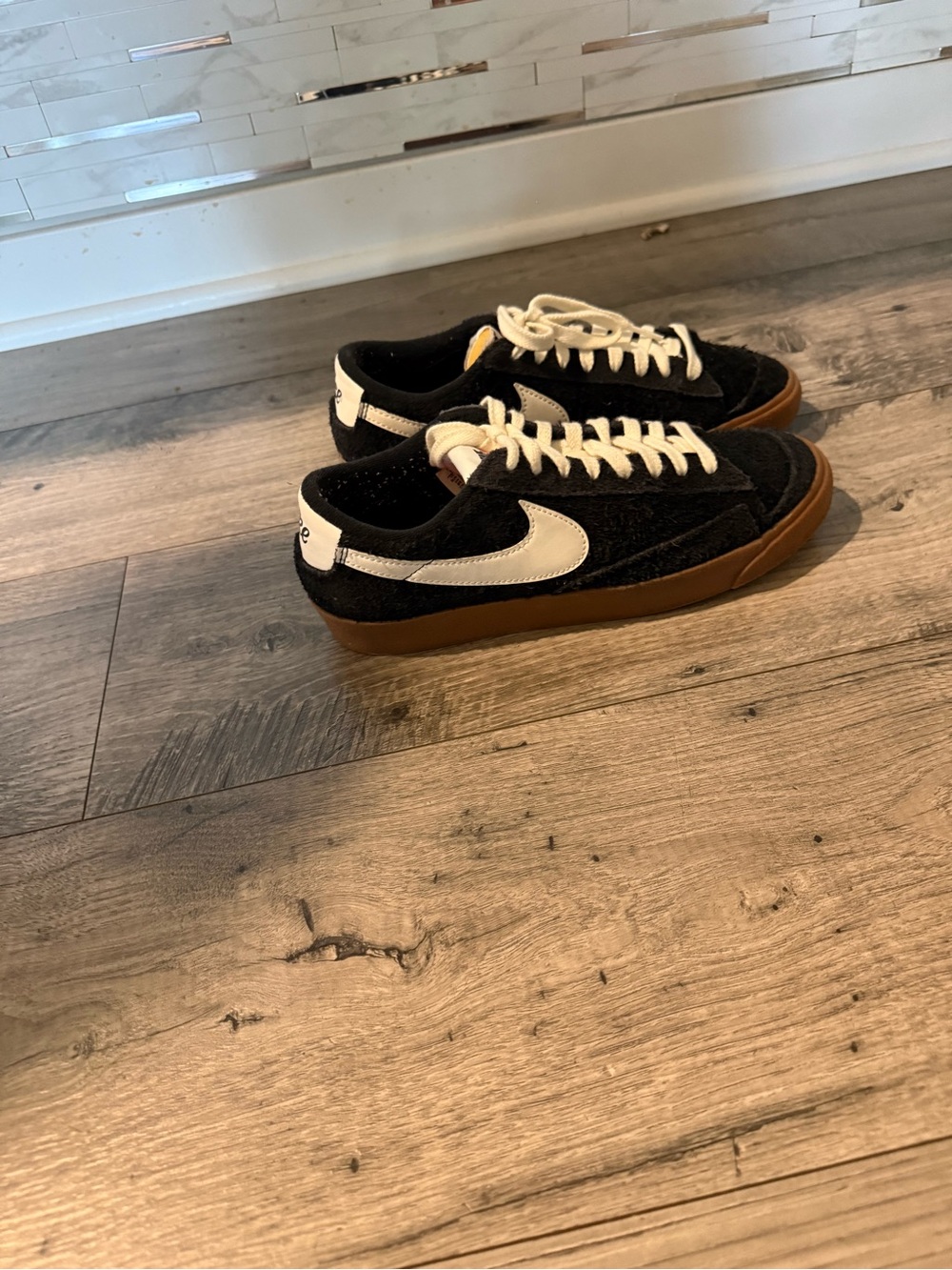 Nike Black Suede Low-Top Sneakers with White Swoosh and Gum Sole